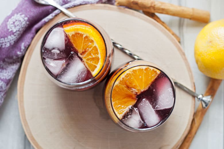 This orange red wine spritzer is a great cocktail for any season. Mix up a batch of cinnamon simple syrup, grab a bottle of your favorite red and try this drink today!