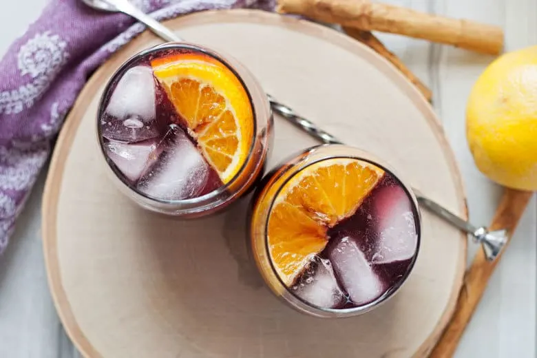 This orange red wine spritzer is a great cocktail for any season. Mix up a batch of cinnamon simple syrup, grab a bottle of your favorite red and try this drink today!