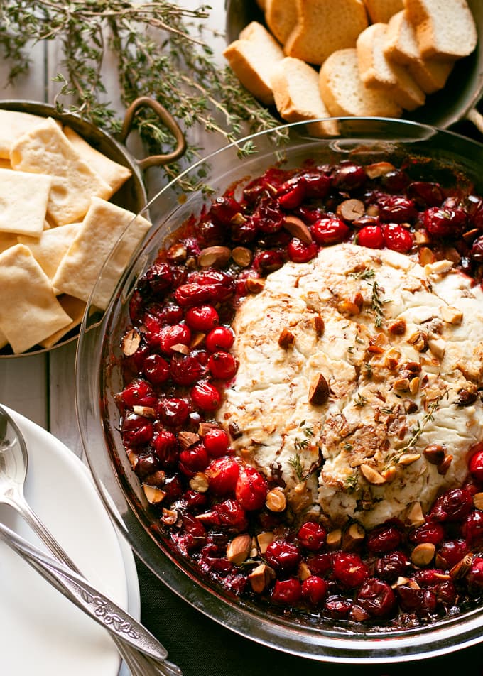 This fancy baked goat cheese roasted cranberry appetizer recipe is easier to make than it looks! It is the perfect appetizer for holiday gatherings like Thanksgiving and Christmas! | honeyandbirch.com