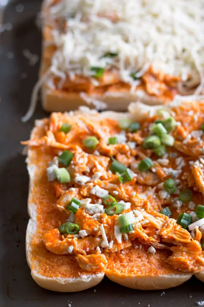 This buffalo chicken pizza bread recipe is going to be a hit at your next party! It's made with KING’S HAWAIIAN® Sweet Bread Rolls for easy eating and is the perfect appetizer or lunch! | honeyandbirch.com