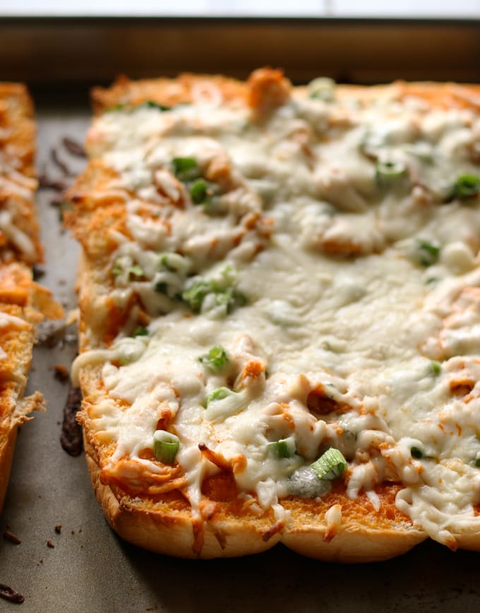 This buffalo chicken pizza bread recipe is going to be a hit at your next party! It's made with KING’S HAWAIIAN® Sweet Bread Rolls for easy eating and is the perfect appetizer or lunch! | honeyandbirch.com