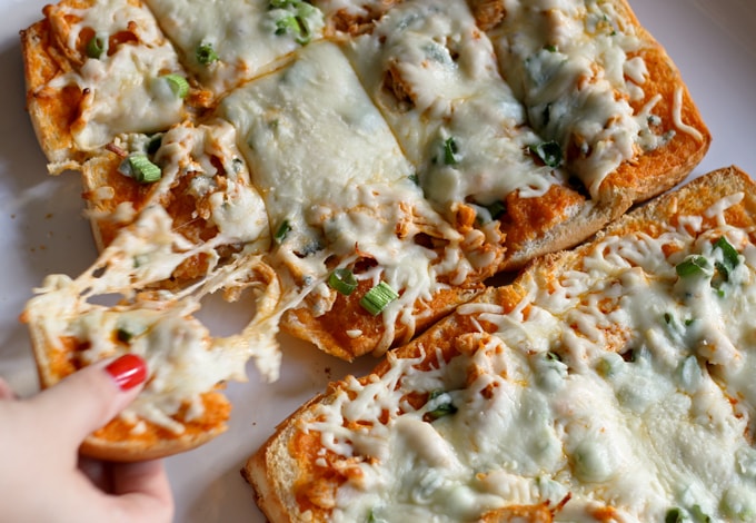 This buffalo chicken pizza bread recipe is going to be a hit at your next party! It's made with KING’S HAWAIIAN® Sweet Bread Rolls for easy eating and is the perfect appetizer or lunch! | honeyandbirch.com