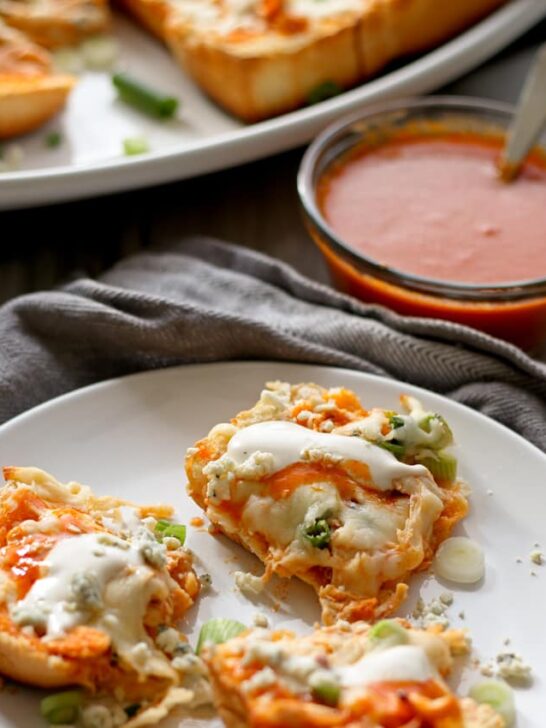 This buffalo chicken pizza bread recipe is going to be a hit at your next party! It's made with KING’S HAWAIIAN® Sweet Bread Rolls for easy eating and is the perfect appetizer or lunch! | honeyandbirch.com