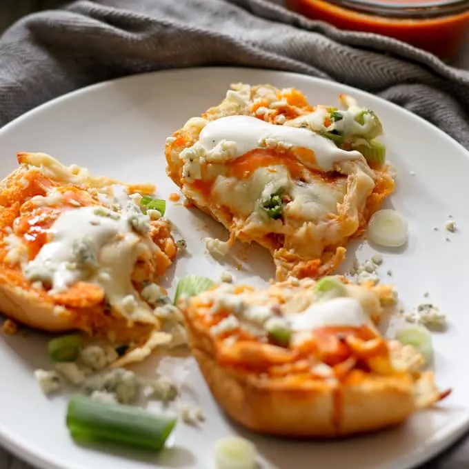 This buffalo chicken pizza bread recipe is going to be a hit at your next party! It's made with KING’S HAWAIIAN® Sweet Bread Rolls for easy eating and is the perfect appetizer or lunch! | honeyandbirch.com