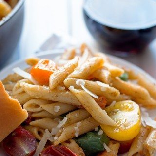 One Pot tomato pesto pasta - 30 minute dinners are my favorite kind of dinners. Use store bought or homemade pesto, cherry tomatoes and shaved parmesan cheese to create this flavorful and easy pasta dinner! | honeyandbirch.com