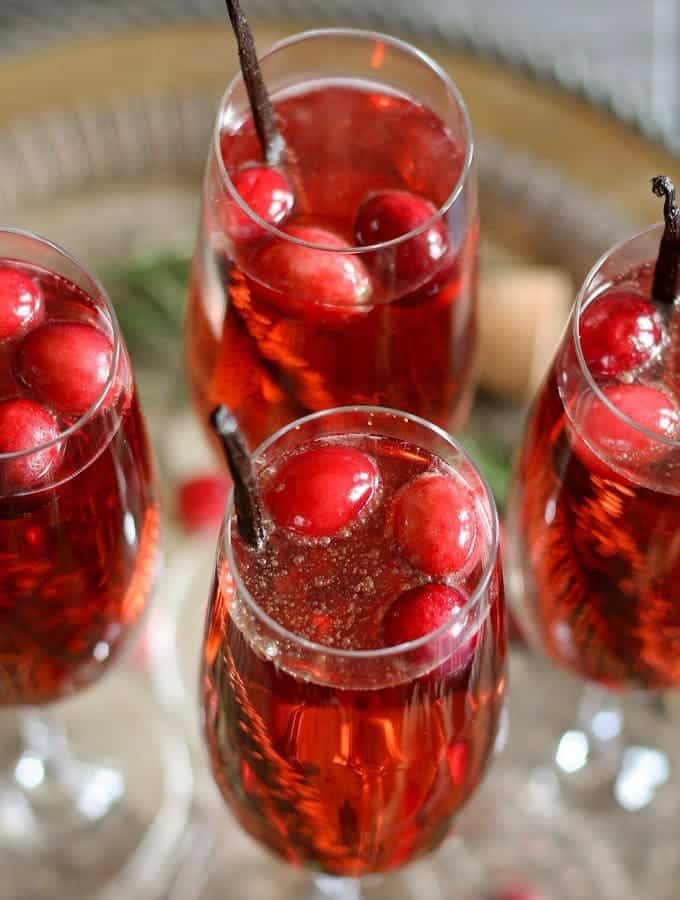 This vanilla cranberry mimosa cocktail is perfect for winter brunches, Christmas, and holiday and New Year's Eve parties! This drink recipe only requires 3 ingredients and is very easy to make. | honeyandbirch.com