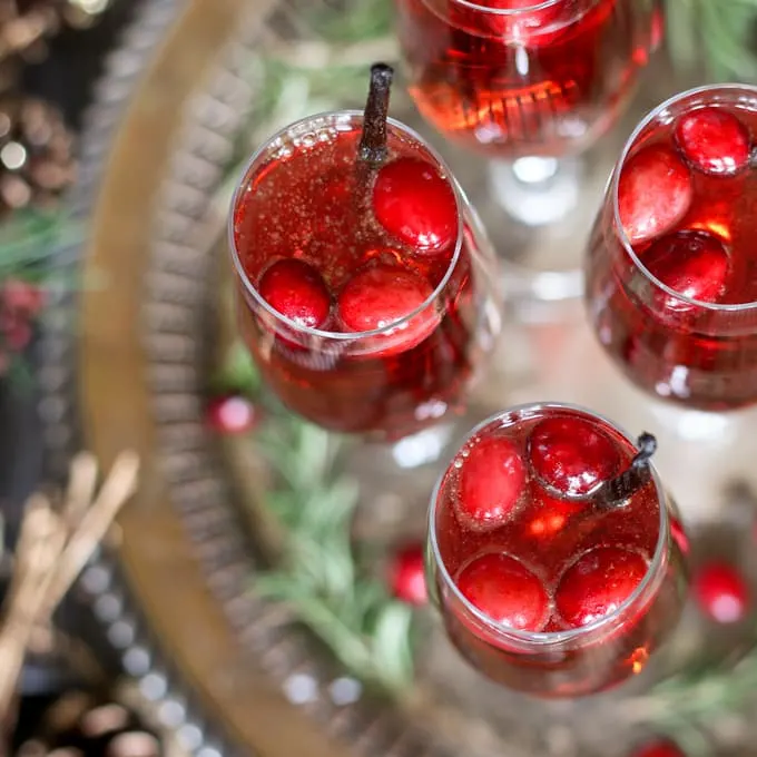 This vanilla cranberry mimosa cocktail is perfect for winter brunches, Christmas, and holiday and New Year's Eve parties! This drink recipe only requires 3 ingredients and is very easy to make. | honeyandbirch.com