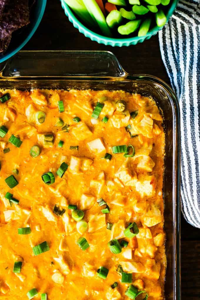 overhead photo of buffalo chicken dip in a clear baking dish