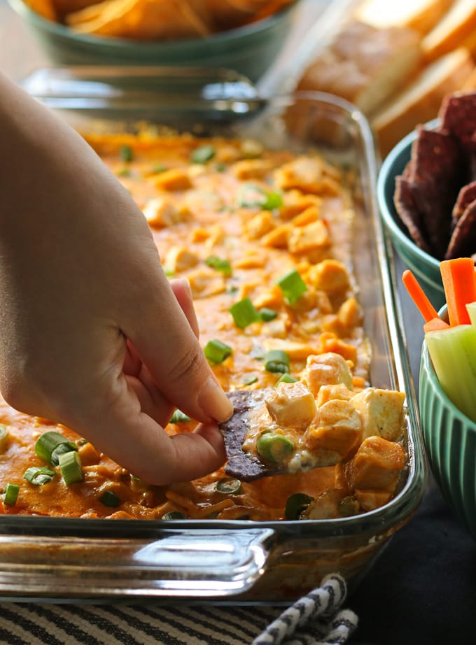 This buffalo chicken dip recipe is the perfect game day food! It tastes just like buffalo wings but with less mess and no frying. Serve it with chips, bread chunks or carrots and celery. | honeyandbirch.com