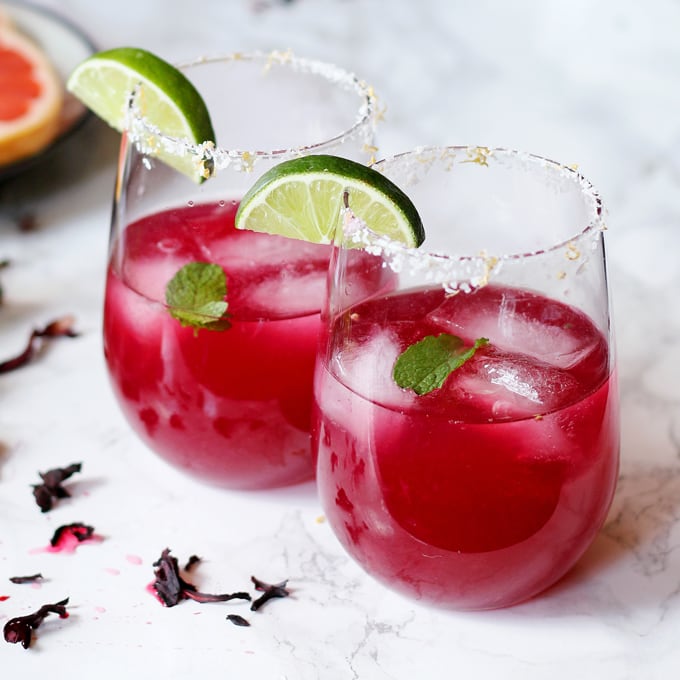 This grapefruit hibiscus margarita is the perfect cocktail recipe to make you think of summer! Fresh grapefruit and lime juice, homemade hibiscus simple syrup and a little muddled mint make this a fun and tropical cocktail! | honeyandbirch.com