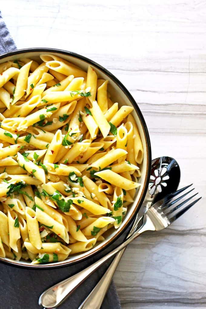 penne aglio e olio on a marble table