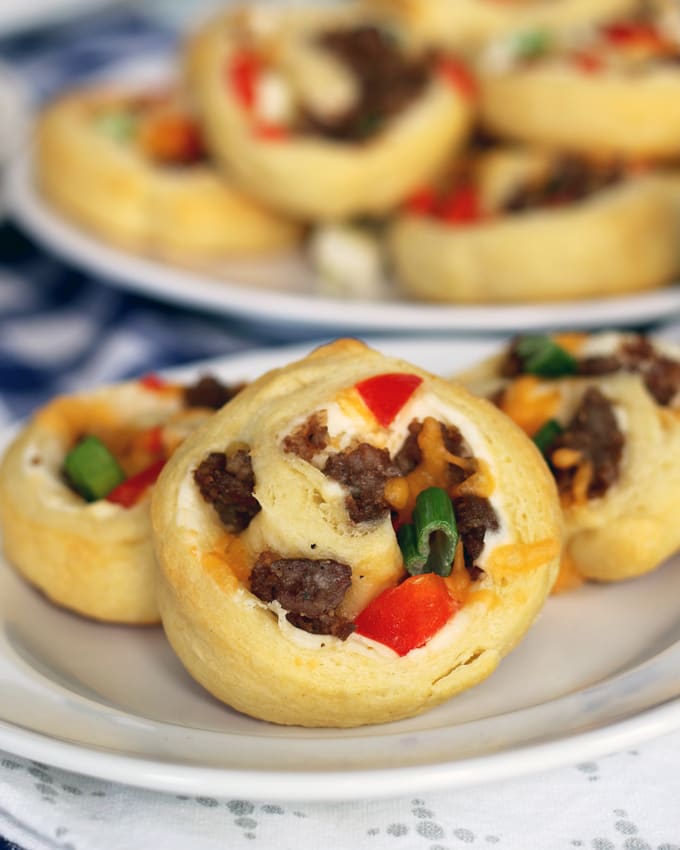 If you're looking for game day food, this sausage pinwheel appetizer is going to be your new favorite recipe for tailgating season. It's made with sausage, refrigerated crescent rolls, red bell peppers and two types of cheese;it's an easy and delicious appetizer to add to your party. Just serve it with a little ranch! | honeyandbirch.com