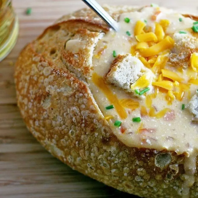 This slow cooker beer cheese soup is super easy to make! It combines sharp cheddar cheese, cream cheese and beer and is delicious for lunch or dinner. Serve it with crusty bread or like me, in a sour dough bread bowl! | honeyandbirch.com