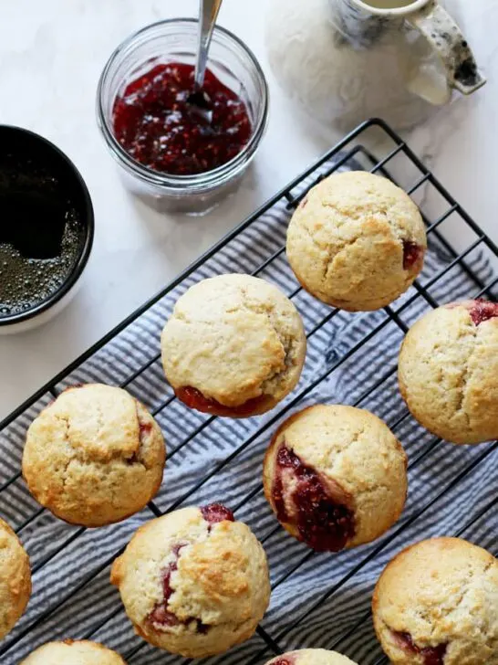 These easy muffins filled with jam are the perfect quick breakfast! I like to eat one or two in the morning with a piping hot cup of coffee. It's such an easy recipe to make that you can make a batch when you wake up. Also, they are perfect for farmer's market preserves and jams! | honeyandbirch.com