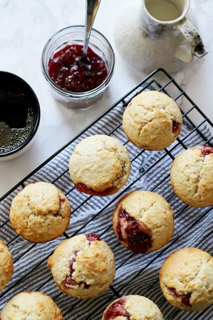 These easy muffins filled with jam are the perfect quick breakfast! I like to eat one or two in the morning with a piping hot cup of coffee. It's such an easy recipe to make that you can make a batch when you wake up. Also, they are perfect for farmer's market preserves and jams! | honeyandbirch.com