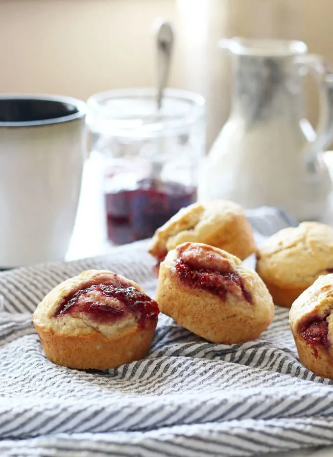 pile of muffins with cup of coffee in the background