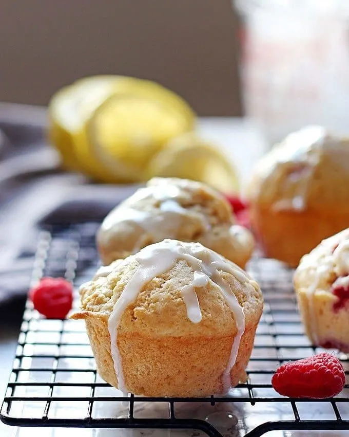These raspberry lemon muffins with lemon glaze are sweet and tart at the same time! They are perfect for brunches, breakfast or snacks on-the-go! | honeyandbirch.com