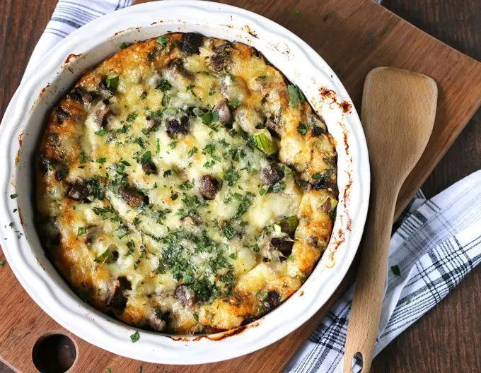 This asparagus mushroom swiss egg bake is perfect for brunch or breakfast! It can be prepared overnight and most of the cooking is done in the oven. Consider making this easy recipe your go to Mother's Day recipe! | honeyandbirch.com