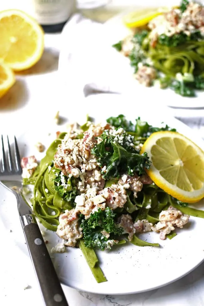 This carbonara-inspired Greek kale pasta is a one-of-a-kind pasta dinner. The flavors of carbonara sauce (bacon!) are combined with elements of Greek cuisine for a savory and delicious dish. | honeyandbirch.com