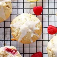 These raspberry lemon muffins with lemon glaze are sweet and tart at the same time! They are perfect for brunches, breakfast or snacks on-the-go! | honeyandbirch.com