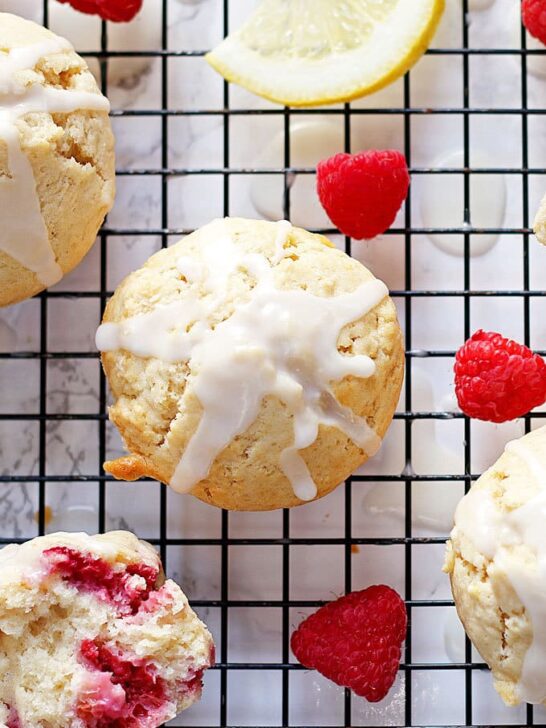 These raspberry lemon muffins with lemon glaze are sweet and tart at the same time! They are perfect for brunches, breakfast or snacks on-the-go! | honeyandbirch.com