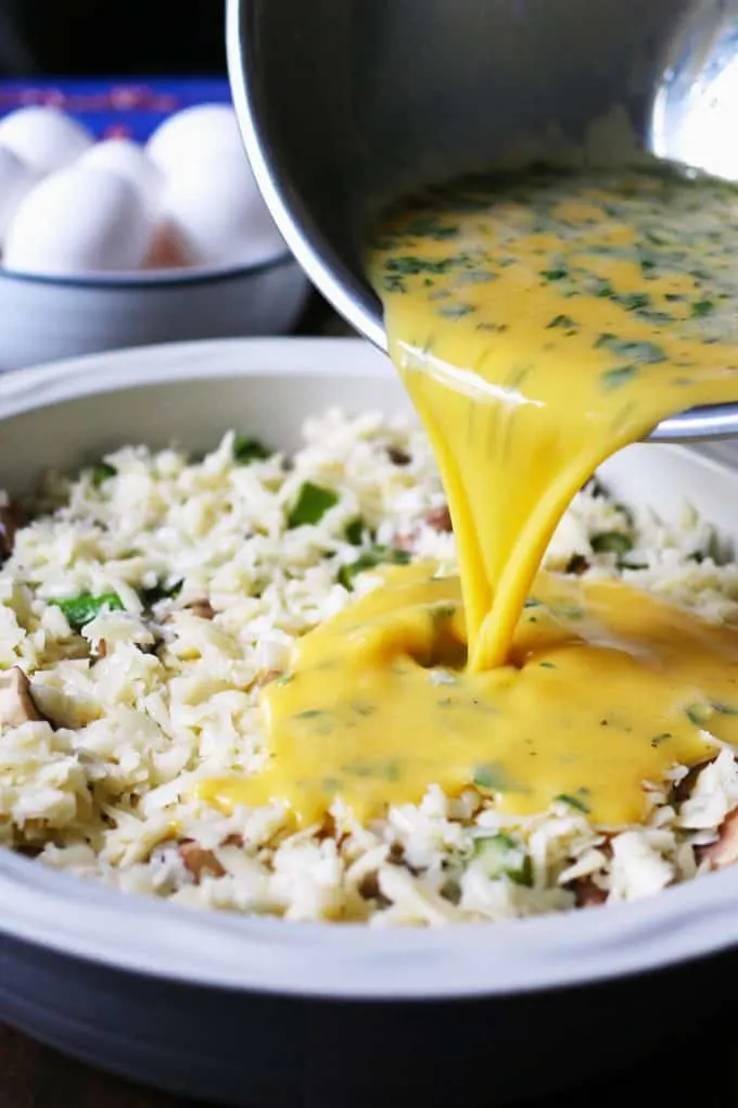 whisked eggs being poured into a casserole dish