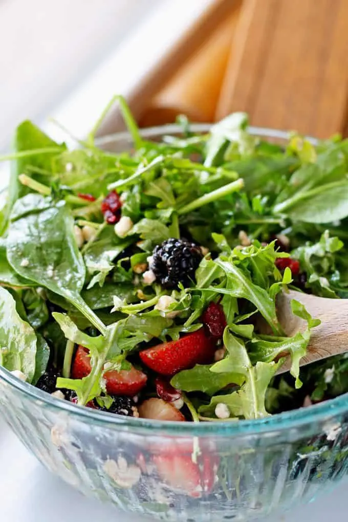 tossed berry goat cheese salad in glass bowl