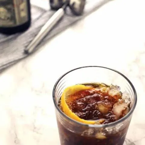 The black stripe cold rum cocktail is a fantastic drink with a surprise ingredient - molasses! If you are looking for something sweeter, add honey; if not, just enjoy the molasses and dark rum all on their own over crushed ice. | honeyandbirch.com