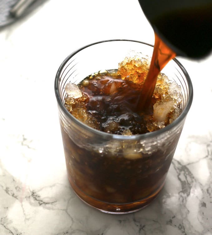 The black stripe cold rum cocktail is a fantastic drink with a surprise ingredient - molasses! If you are looking for something sweeter, add honey; if not, just enjoy the molasses and dark rum all on their own over crushed ice. | honeyandbirch.com