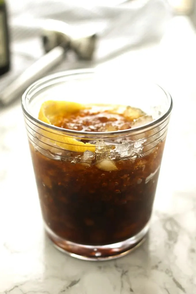 The black stripe cold rum cocktail is a fantastic drink with a surprise ingredient - molasses! If you are looking for something sweeter, add honey; if not, just enjoy the molasses and dark rum all on their own over crushed ice. | honeyandbirch.com