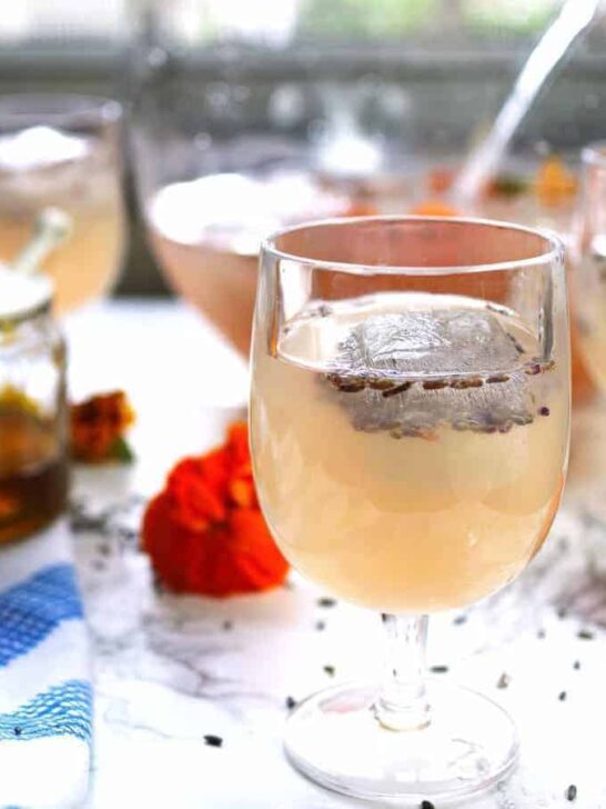 This boozy honey lavender lemonade is a great drink for brunches. It is also the PERFECT punch for spring and summer bridal or baby showers. | honeyandbirch.com