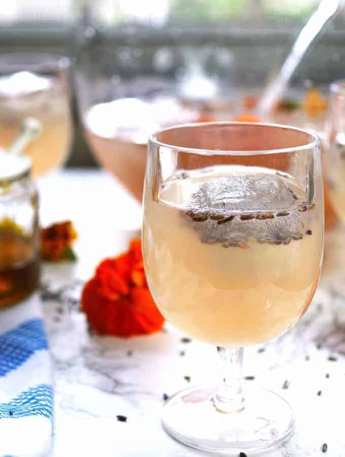 This boozy honey lavender lemonade is a great drink for brunches. It is also the PERFECT punch for spring and summer bridal or baby showers. | honeyandbirch.com