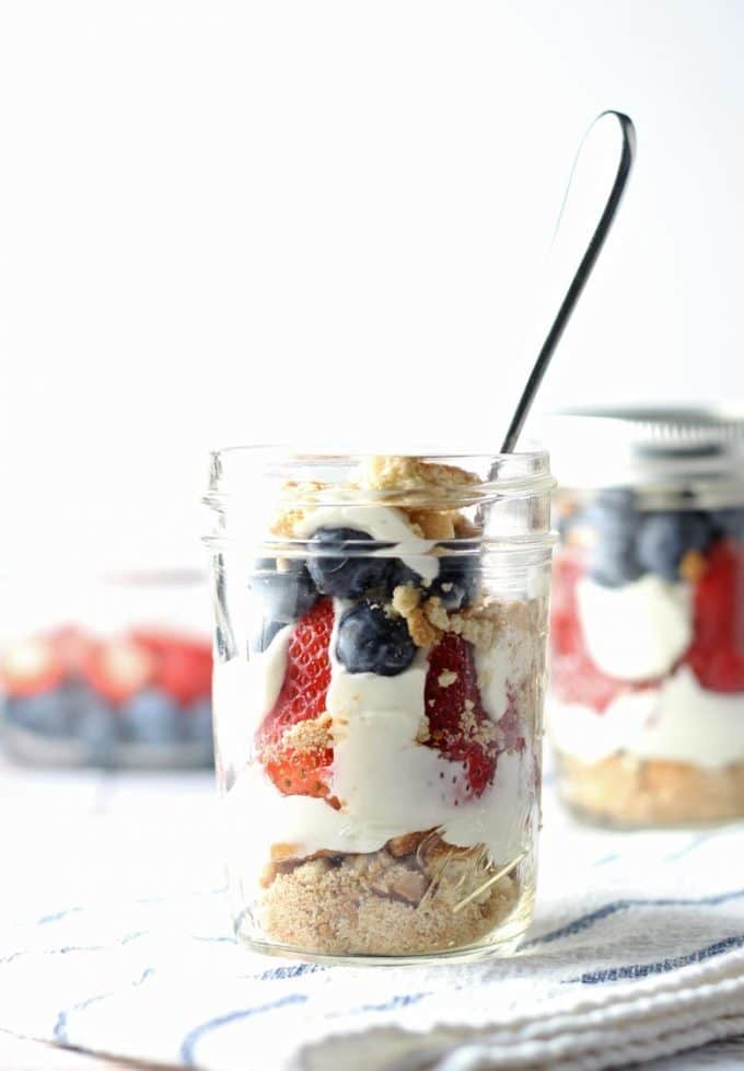 red white and blue cheesecake parfait in a mason jar