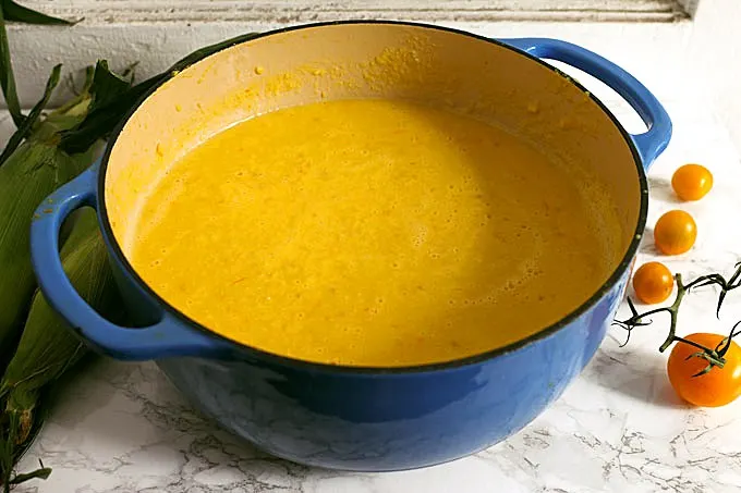 This sweet corn yellow tomato soup is a taste of pure summer and straight out of Heather Christo's book Pure Delicious. Top it with a dash of cilantro sauce and you're day will be made! | honeyandbirch.com