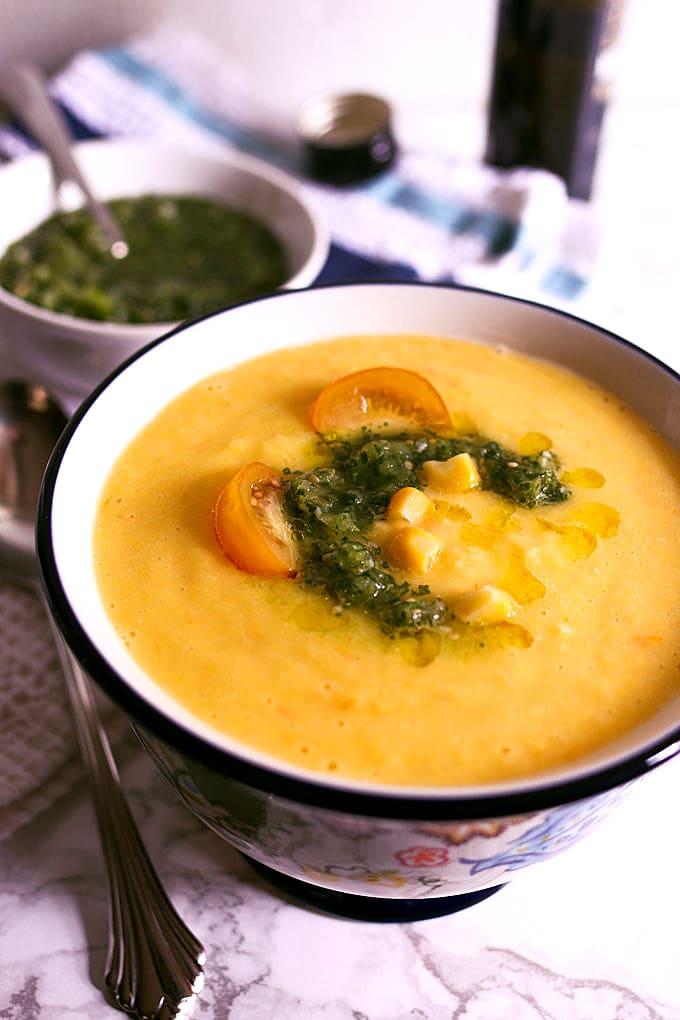 This sweet corn yellow tomato soup is a taste of pure summer and straight out of Heather Christo's book Pure Delicious. Top it with a dash of cilantro sauce and you're day will be made! | honeyandbirch.com