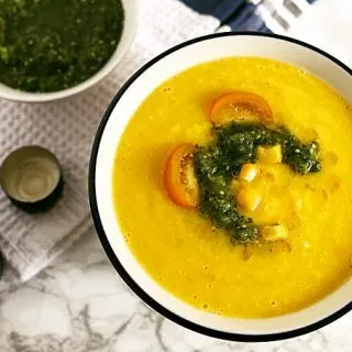 This sweet corn yellow tomato soup is a taste of pure summer and straight out of Heather Christo's book Pure Delicious. Top it with a dash of cilantro sauce and you're day will be made! | honeyandbirch.com