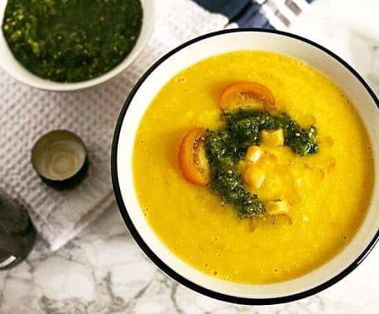 This sweet corn yellow tomato soup is a taste of pure summer and straight out of Heather Christo's book Pure Delicious. Top it with a dash of cilantro sauce and you're day will be made! | honeyandbirch.com