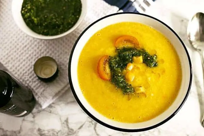 This sweet corn yellow tomato soup is a taste of pure summer and straight out of Heather Christo's book Pure Delicious. Top it with a dash of cilantro sauce and you're day will be made! | honeyandbirch.com