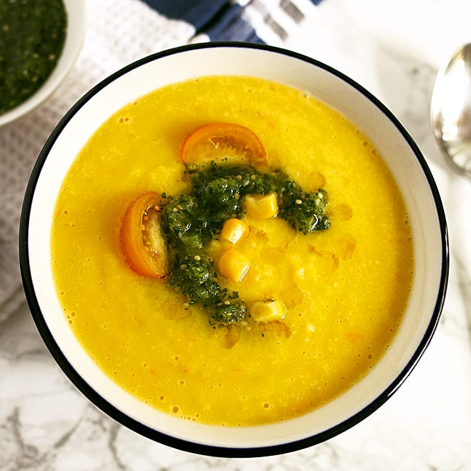 This sweet corn yellow tomato soup is a taste of pure summer and straight out of Heather Christo's book Pure Delicious. Top it with a dash of cilantro sauce and you're day will be made! | honeyandbirch.com