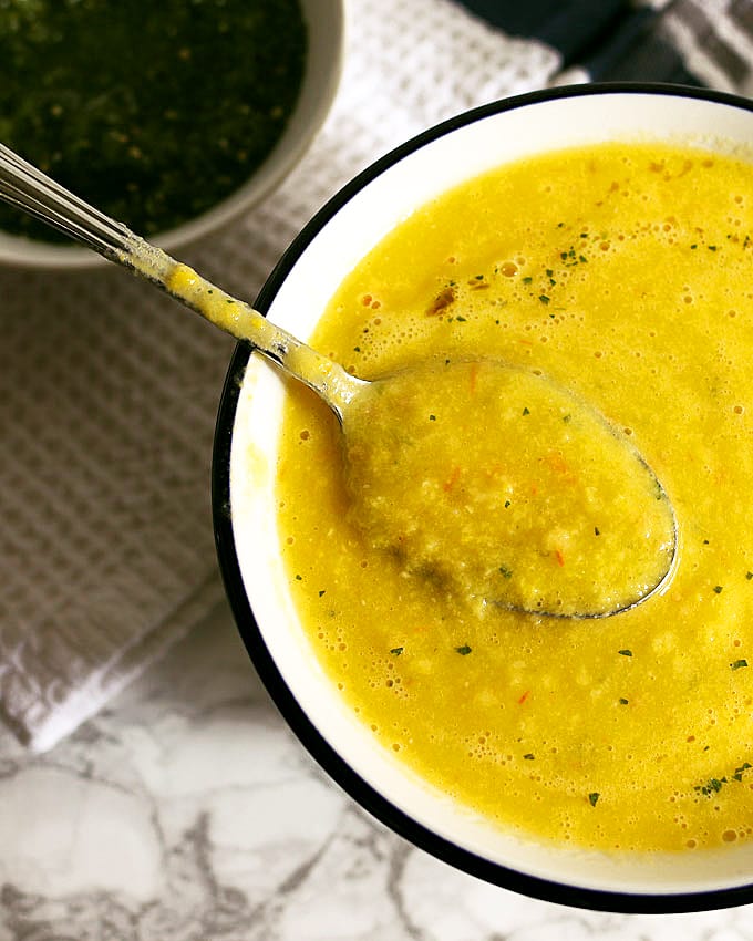 This sweet corn yellow tomato soup is a taste of pure summer and straight out of Heather Christo's book Pure Delicious. Top it with a dash of cilantro sauce and you're day will be made! | honeyandbirch.com