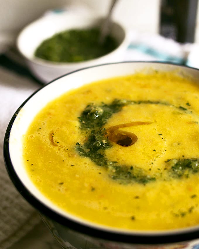 This sweet corn yellow tomato soup is a taste of pure summer and straight out of Heather Christo's book Pure Delicious. Top it with a dash of cilantro sauce and you're day will be made! | honeyandbirch.com