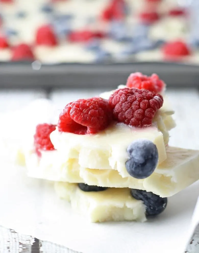 Looking for a fun patriotic dessert that is a little healthier? Try this red white and blue frozen yogurt bark. It's full of berries and sweetened with honey for a perfect holiday dessert! | honeyandbirch.com