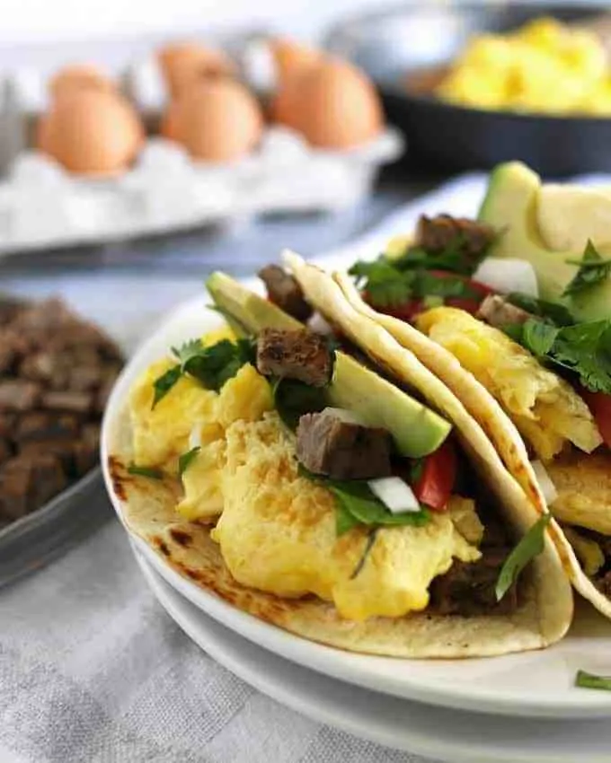 Steak and egg breakfast tacos are a great spin on a traditional diner breakfast. Add your favorite taco toppings! Also great for Father’s Day morning and steak lovers! | honeyandbirch.com