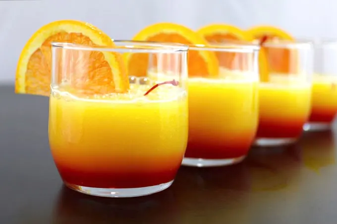 These tequila sunrise slushies are going to be your go-to summer party drink! You can easily multiply the recipe for a pitcher. Only 3 ingredients! | honeyandbirch.com