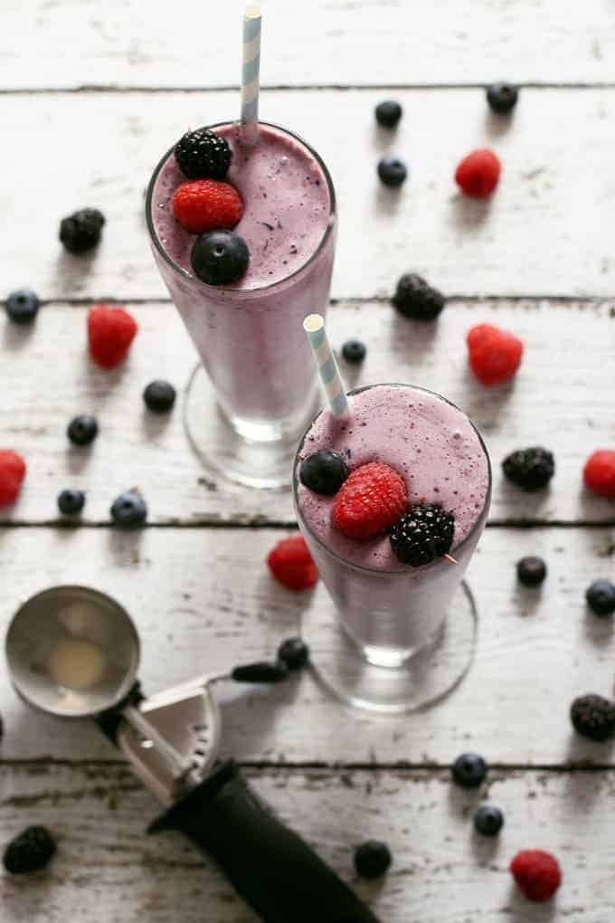 two mixed berry milkshakes and an ice cream scooper