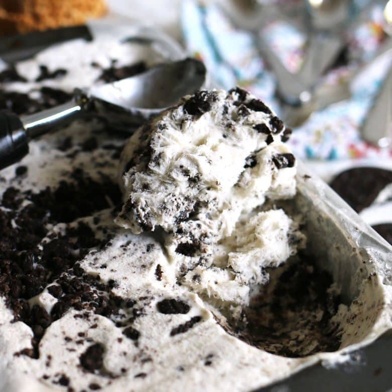 cookies and cream ice cream being scooped out of a pan
