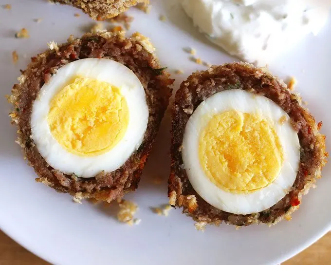 These baked scotch eggs are the perfect party appetizer! Serve them with my shallot yogurt dip; your guests will definitely come back for more! | honeyandbirch.com