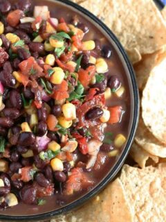 My no cook corn black bean salsa recipe takes 10 minutes to make and is perfect for parties, tailgating and holidays. Make this your new favorite quick appetizer! | honeyandbirch.com