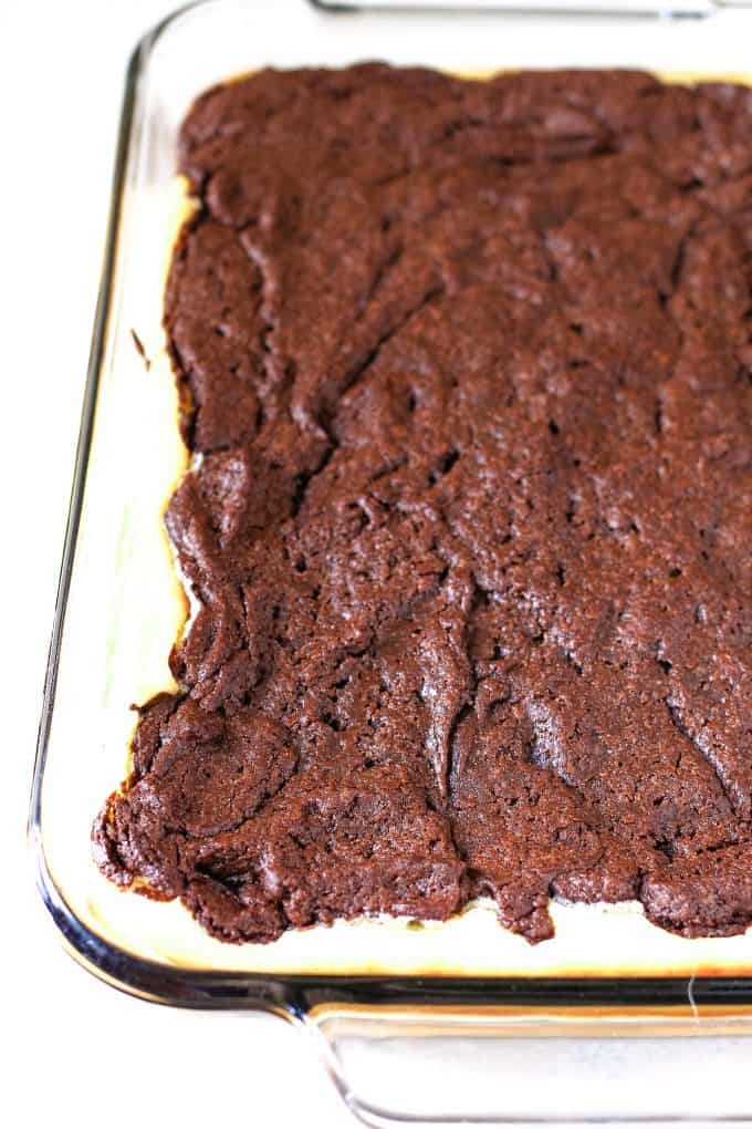 cooked cream cheese brownies in a glass baking dish