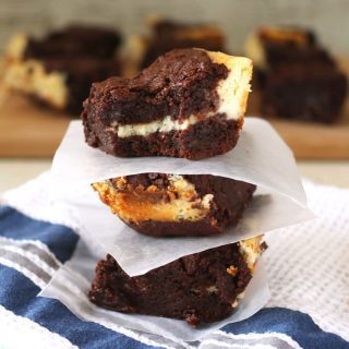 These cream cheese fudge brownies are decadently delicious! A smooth cream cheese layer is sandwiched between two layers of chocolate fudge. | honeyandbirch.com